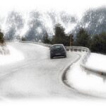 Car driving a curving road in Winter, Estes National Park