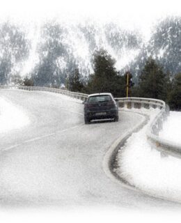Car driving a curving road in Winter, Estes National Park