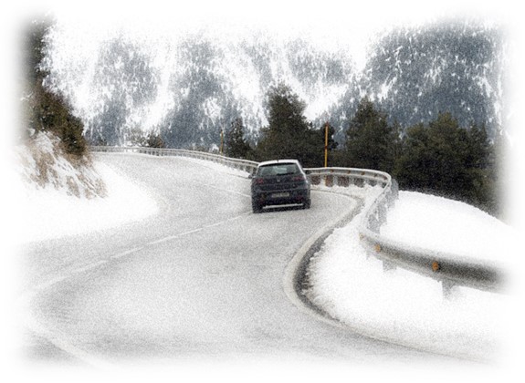 Car driving a curving road in Winter, Estes National Park