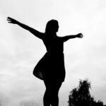 woman standing with wide open arms