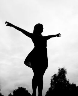 woman standing with wide open arms