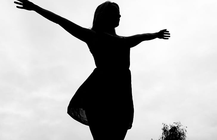 woman standing with wide open arms