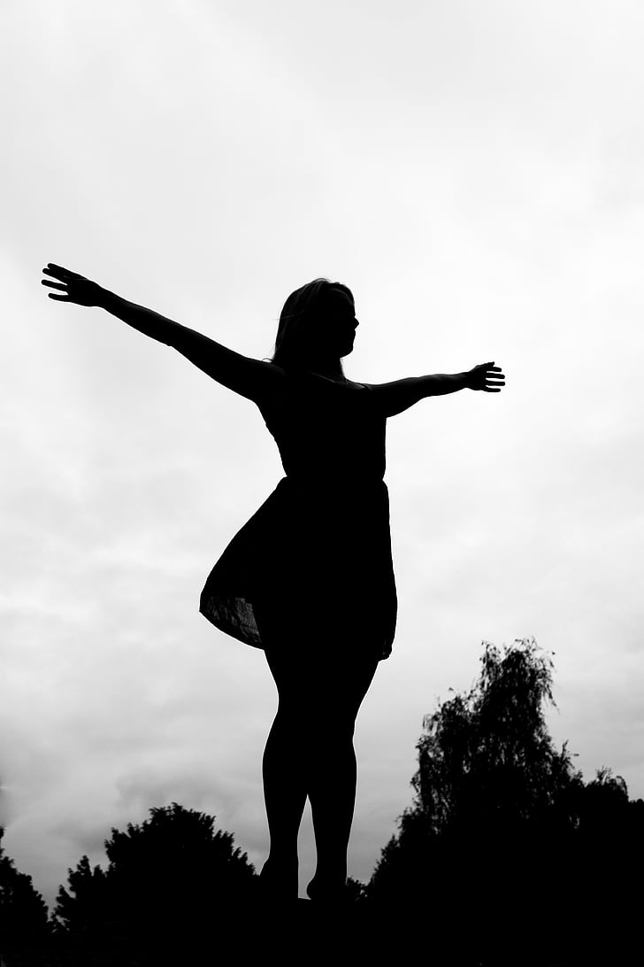 woman standing with wide open arms
