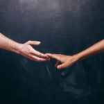 a couple holding hands, grasps slipping