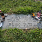 Gravestone of Jack Kerouac with items left by admirers