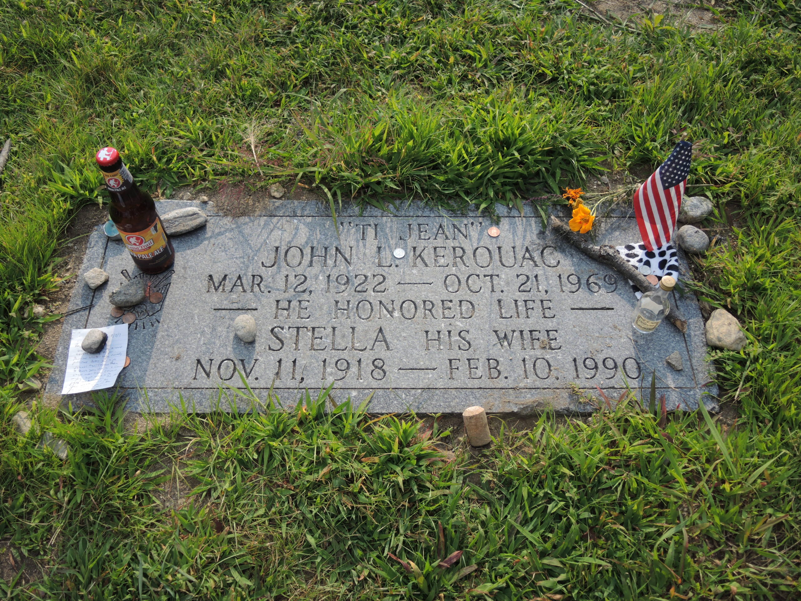 Gravestone of Jack Kerouac with items left by admirers