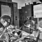 Looking through a window into a classroom. A pile of equipment sits in the foreground.