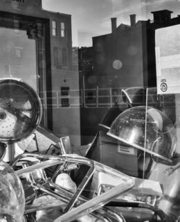 Looking through a window into a classroom. A pile of equipment sits in the foreground.