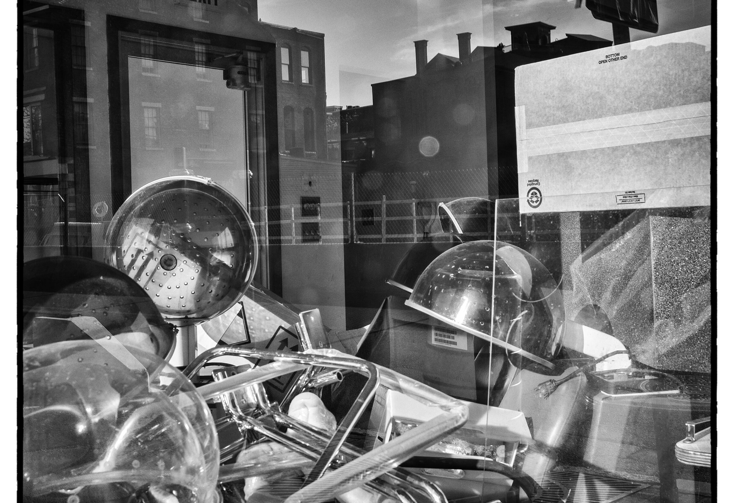 Looking through a window into a classroom. A pile of equipment sits in the foreground.