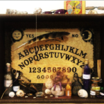 Shadow-box still life with Ouija board, artifacts, potions and shells