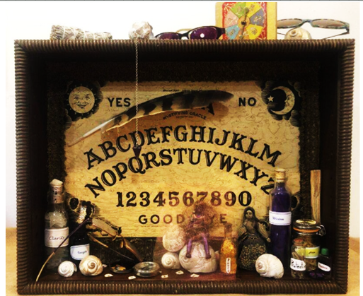 Shadow-box still life with Ouija board, artifacts, potions and shells