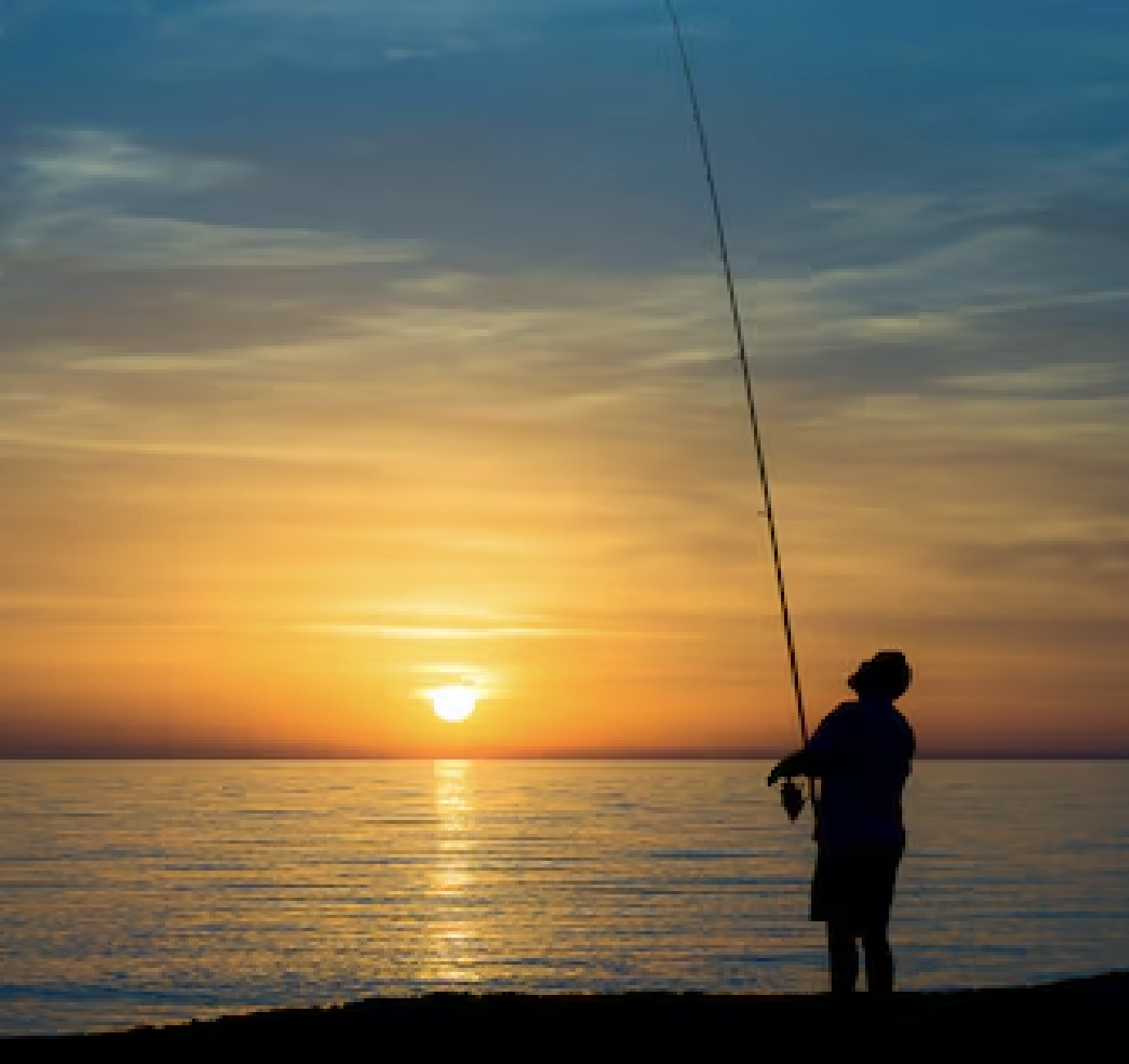 a man fishing at sunset