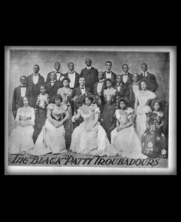 Formal black & white photo of The Black Patti Troubadours in late 1800s