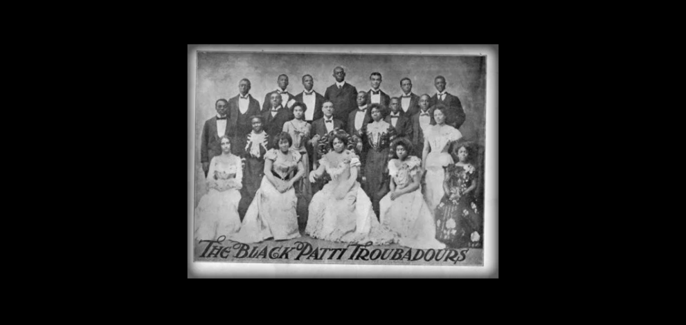 Formal black & white photo of The Black Patti Troubadours in late 1800s
