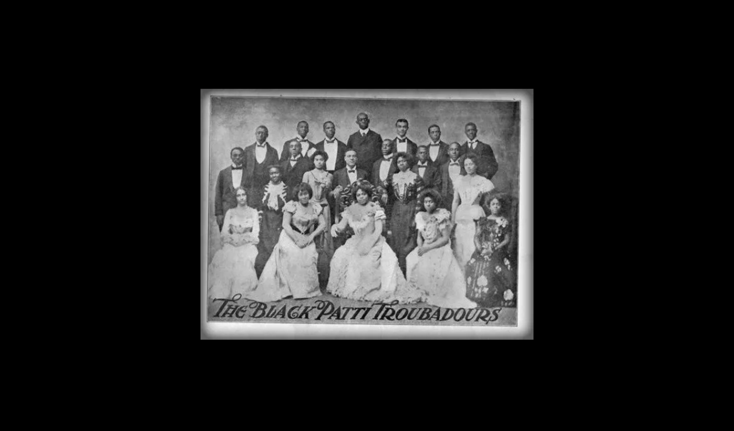 Formal black & white photo of The Black Patti Troubadours in late 1800s